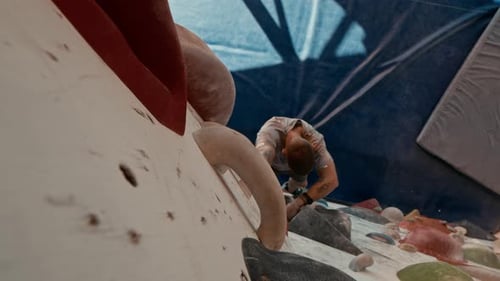 Man Climbing Rock Wall at Indoor Gym