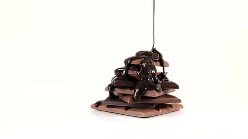 Chocolate Sauce Poured Over Stacked Milk Chocolate Squares