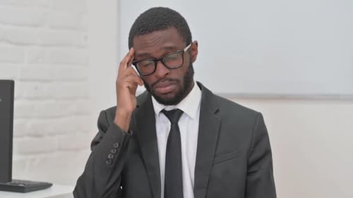 Young African Businessman Suffering from Headache