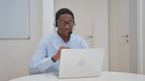 African American Businessman with Headset in Call Center Doing Video Chat