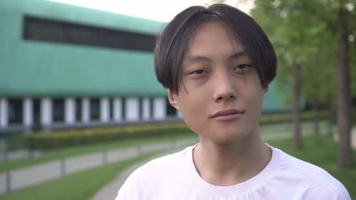 Young Adult With Dark Hair Outdoors in Park