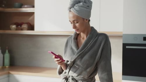 Close Up of Pretty Woman Typing on Smartphone While Cooking Breakfast Beautiful Caucasian Female