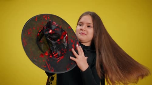 Girl Smiles and Dances in Witch Halloween Costume