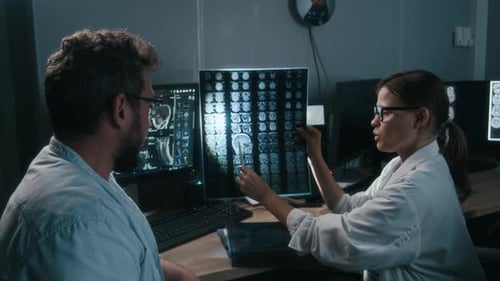 Doctors Analyzing Brain Scans in Hospital Setting