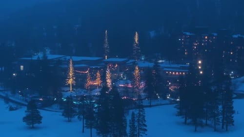Winter Resort Hotel at Night with Festive Lights in Snow