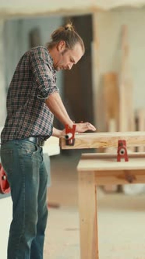 Concentrated Carpenter Gluing Wood Planks Together