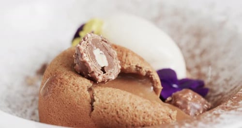 Prepared and decorated dessert in kitchen, slow motion