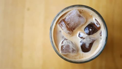 Iced Coffee Drink Being Stirred with Straw
