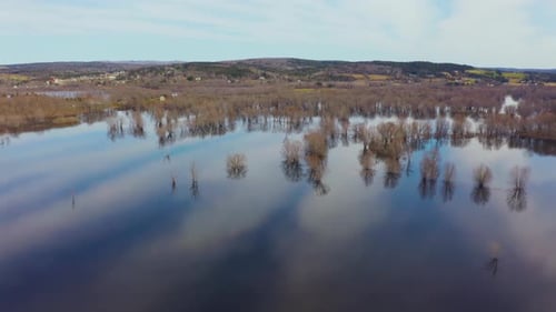 Climate change and global warming demonstrated in an aerial view of a flooded river.