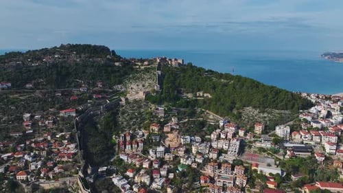Aerial Video of a Large City With the Azure Sea Stretching to the Horizon and Bright Sunlight