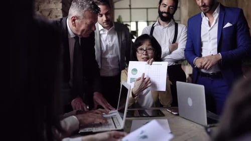 Multiracial business group of people working on financial strategy inside bank office