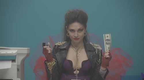 A Woman in a Black Leather Jacket Sits at a Table in the Office Holding Money in Her Hand The Girl