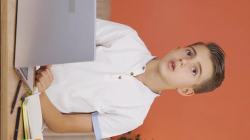 Vertical video of The boy is thoughtful in a hopeless and helpless state.