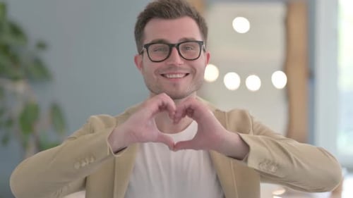 Smiling Man Making Heart Shape With Hands