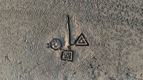 Aerial, screwdriver, drone shot, above drawing on sand, at a beach, on a sunny evening, in Germany