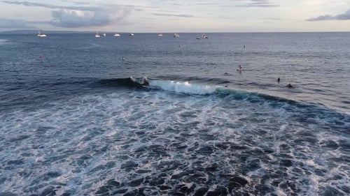 Drone shot of surfer riding an amazing wave in Hawaii