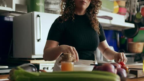 Woman Prepares Red Onion for Salad in Kitchen