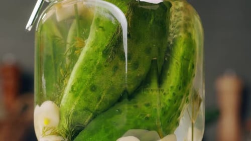 Closeup of Fermented Cucumbers with Garlic in Can Preservation of Vegetables in Glass Jars