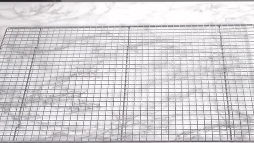 Freshly Baked Golden Rolls being Transferred to Rack