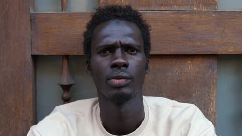 Young Adult Stares Intently at Camera Close Up