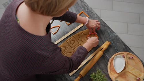Aerial View of Woman Using Orange Cutter to Shape Dough