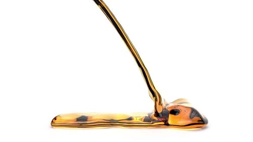 Amber Liquid Flowing on White Surface