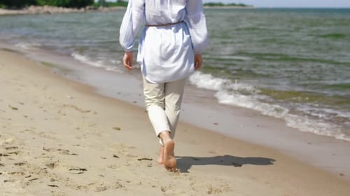 People and Leisure Concept - Woman Walking Barefoot Along Summer Beach Adult
