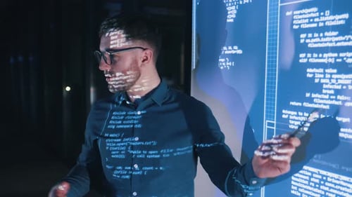 Business coach against projector with data.