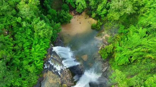 Aerial view over a waterfall in a beautiful tropical forest.