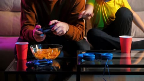 Friends Gaming Together on Couch at Night