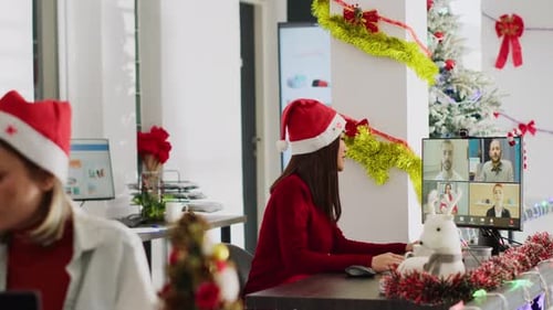 Worker Videocalls Team in Xmas Office