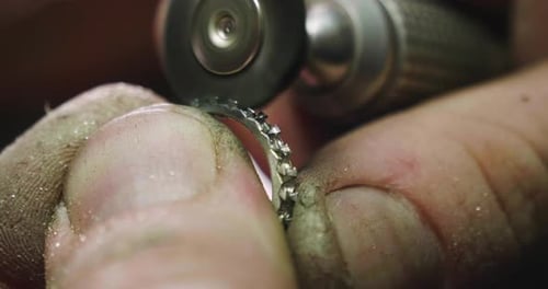 Close up of the hands of a goldsmith while he is working on a diamond ring. Concept: Style, fashio