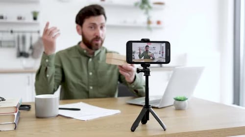 Man Records Video Blog at Home Using Smartphone