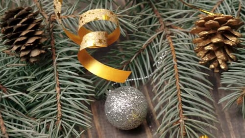 Some presents, Christmas balls, pine cones and little toys of Santa Claus near the Christmas branch