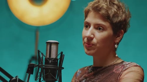 Young Woman Giving Podcast Interview in Modern Recording Studio