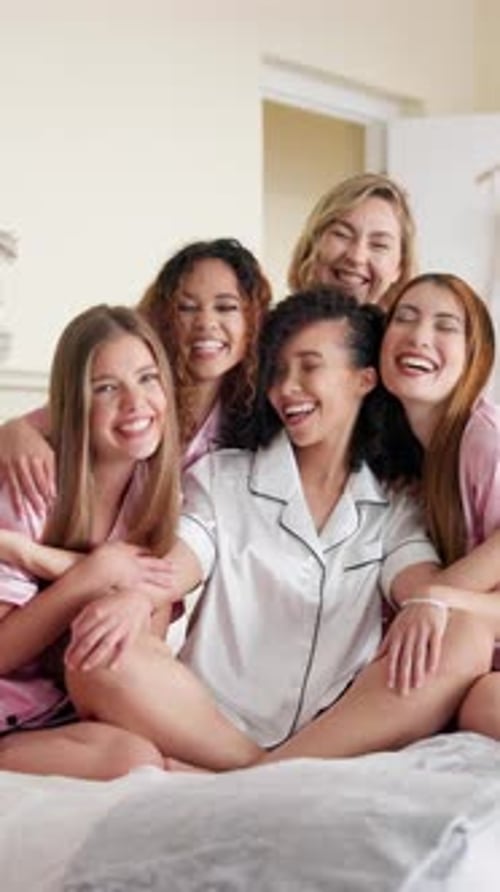 Smiling Young Women Celebrate Together in Pajamas