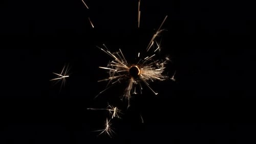 Sparkling Firework Erupts Against Black Background