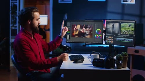 Man Explains Video Editing Process at Desk