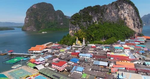 Koh Panyi Fishing Village With Mosque And Island In Phang Nga, Thailand. - aerial shot