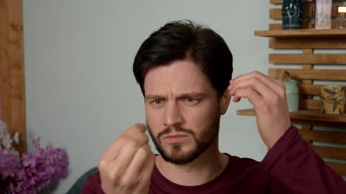 Man Styling Hair in Interior Home Setting