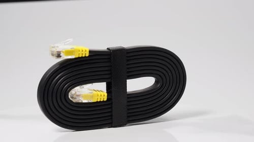 Black Ethernet Cable Coiled With Yellow Connectors