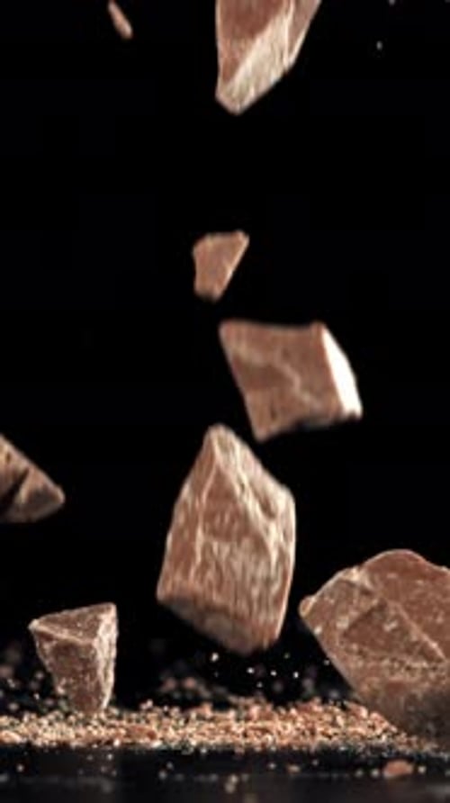 Pieces of Chocolate Fall on the Table Filmed on a Highspeed Camera at 1000 Fps