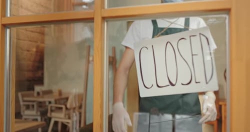 Male Waiter Opening Cafe During Pandemic
