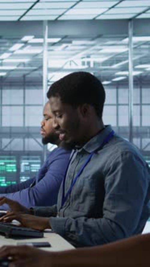 Vertical Video Close Up of Woman in Server Hub Ensuring Optimal System Performance