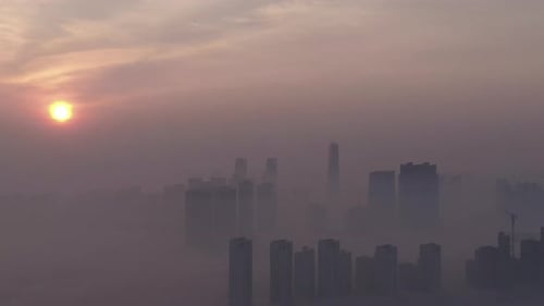 A city that seems to be floating in the air with fog and dust.