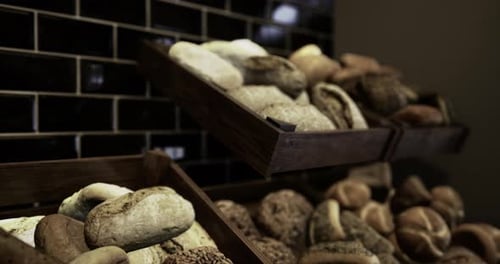 Variety of Fresh Baked Bread Displayed in a Rustic Bakery Setting