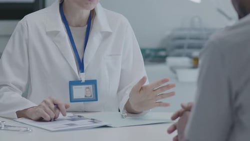 Woman Doctor Consulting with Patient in Clinic