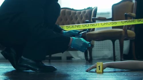 Gloves Investigator Crouches at Crime Scene