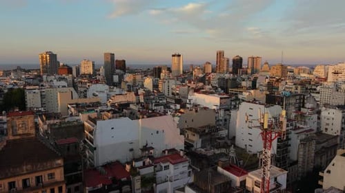 Above Dense Urban Skyline Of Buenos Aires At Sunset In Argentina. Aerial Shot