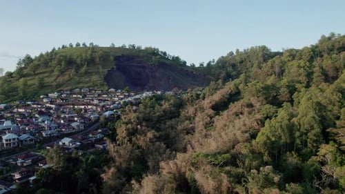 Vista aérea de uma vila densa perto de deslizamento de terra e floresta tropical